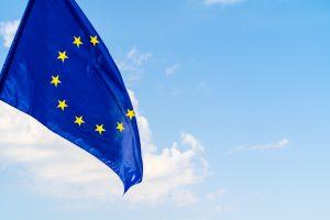 European Union flag against blue sky waving